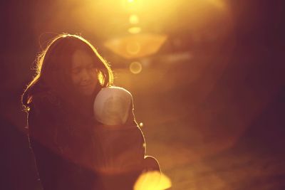 Young woman with light painting on the background