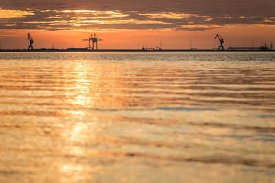 Scenic view of sea against orange sky