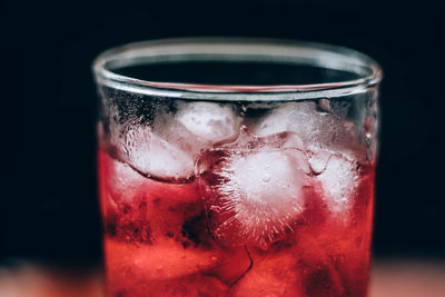 Close-up of red glass against black background