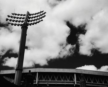 Low angle view of floodlights at lords cricket ground against cloudy sky