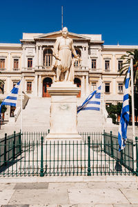 Statue against building in city