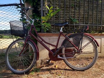 Bicycle parked against brick wall