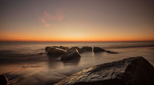 Scenic view of sea against sky at sunset