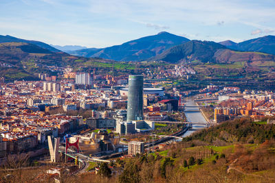 High angle view of townscape and mountains against sky