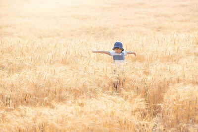 Portrait of smiling boy standing on field