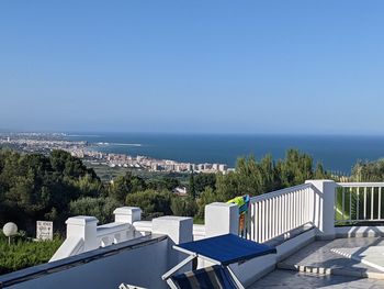 High angle view of townscape against clear blue sky