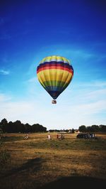 Hot air balloon flying over land