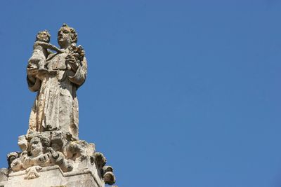 Close-up of statue against clear blue sky