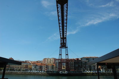 Cranes at construction site against sky in city