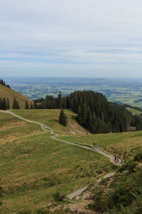 High angle view of road amidst field against sky