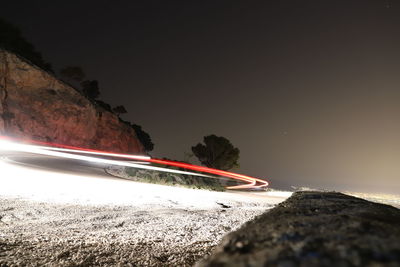 Scenic view of rocks by road against sky