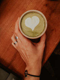 Midsection of woman holding coffee cup