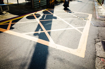 Low section of man walking on road