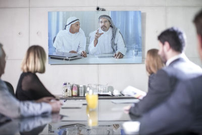 Business people in video conference with clients from the middle east