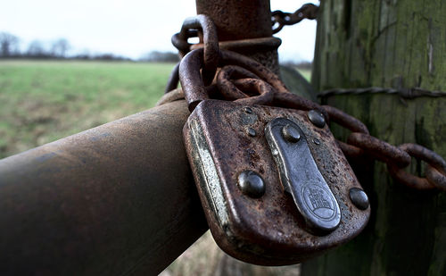 Close-up of rusty chain on field