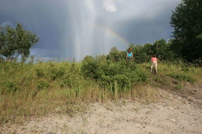 People on field against sky