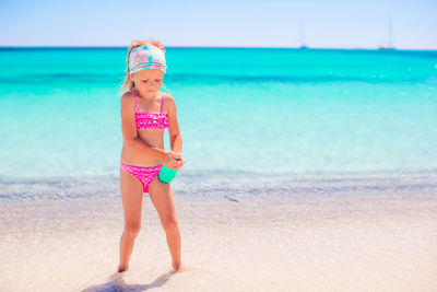 Full length of girl standing on beach