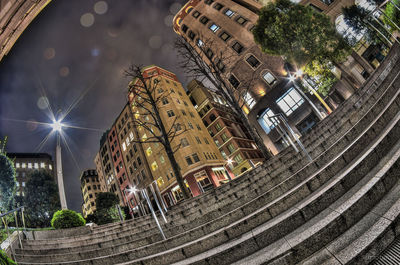 Low angle view of buildings lit up at night