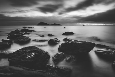 Rocks in sea against sky