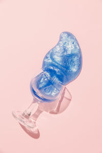 Close-up of glass bottle on table against white background