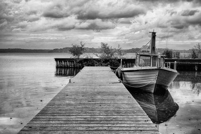 Pier over lake against sky