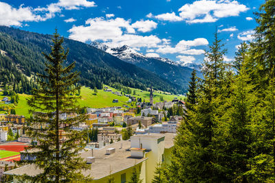 High angle view of townscape by mountains against sky