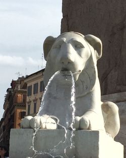 Low angle view of statue against building