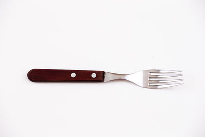 Close-up of fork over white background