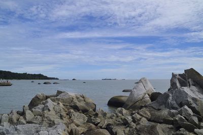 Scenic view of rocks and sea against sky