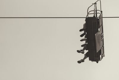 Low angle view of power lines against clear sky