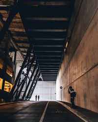 Rear view of man walking in illuminated building