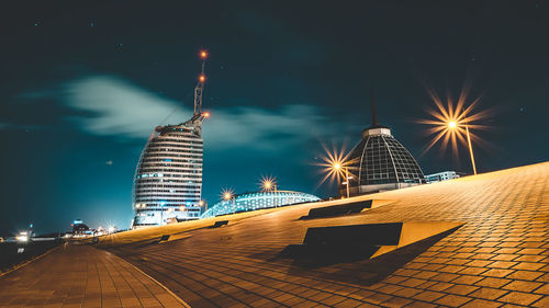 Illuminated modern buildings in city at night