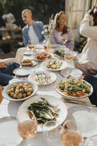 Food with wine arranged on table during dinner party at cafe