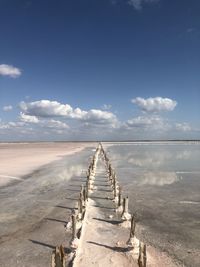 Wooden posts on salt footpath 