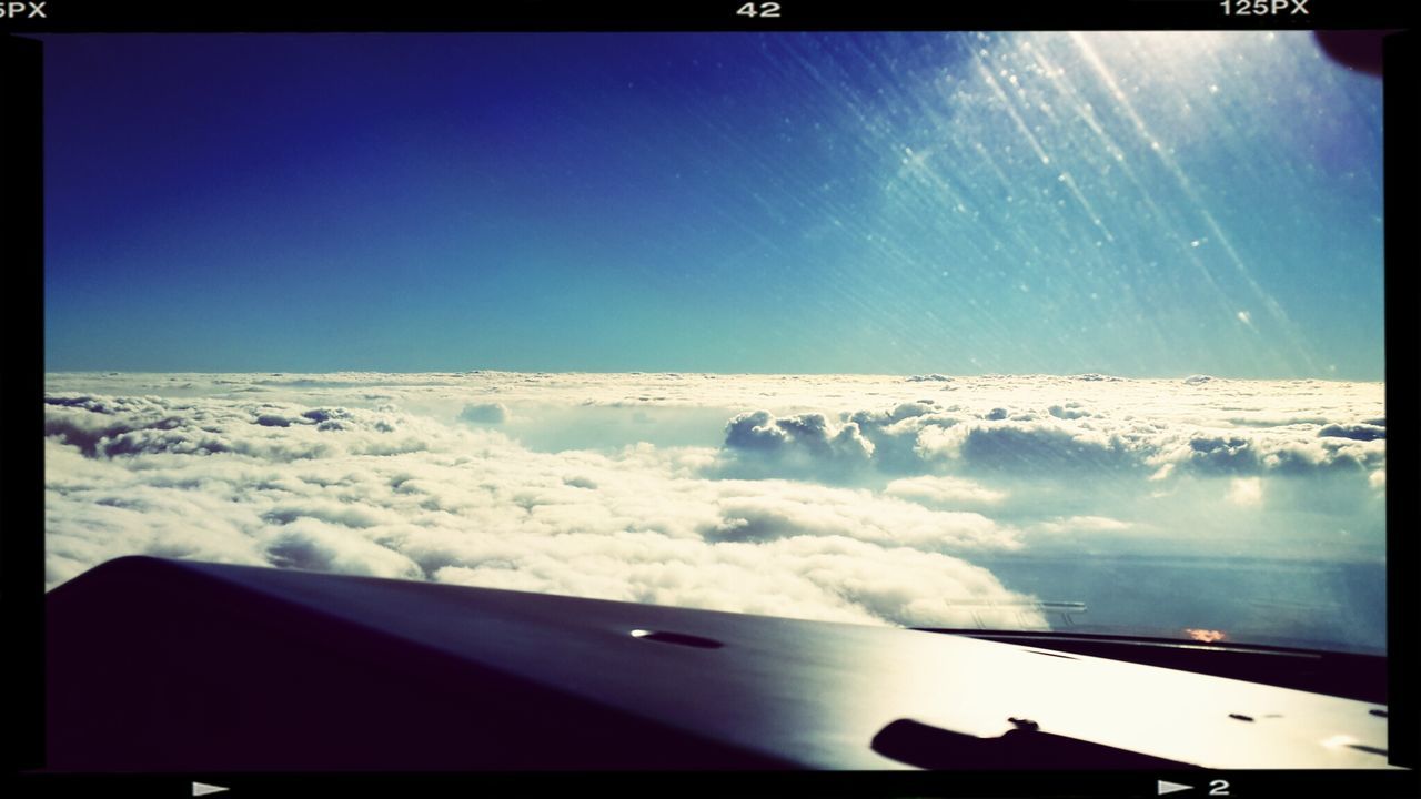 transfer print, scenics, airplane, auto post production filter, beauty in nature, flying, air vehicle, aircraft wing, blue, transportation, sky, nature, mode of transport, tranquil scene, sea, part of, horizon over water, tranquility, clear sky, travel