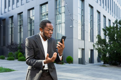 Young businessman using mobile phone