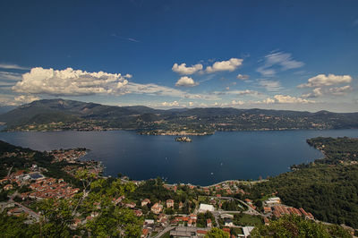 High angle view of city by sea against sky