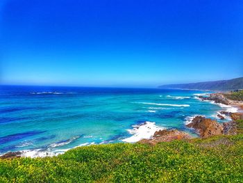 Scenic view of sea against clear blue sky