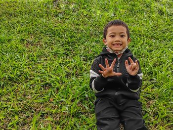 Portrait of boy on grassy field