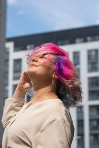 Portrait of woman looking at city