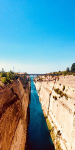 Panoramic view of land against clear blue sky