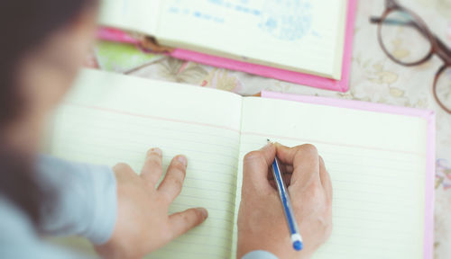 High angle view of hand holding paper