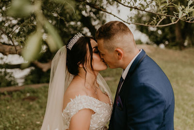 Side view of bride holding bouquet