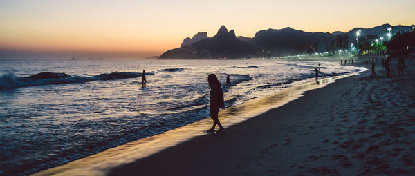 Scenic view of beach against sky during sunset