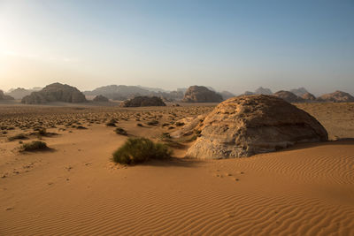 Sand dunes and sandstone cliffs in wadi rum desert , jordan