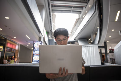 Man holding mobile phone in office