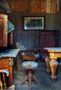 Empty chairs and table in old building