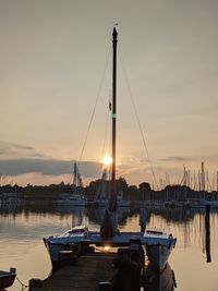 Sailboats in marina at sunset