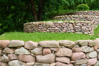 Stack of stone wall in yard