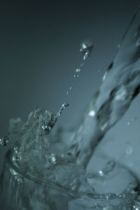 Close-up of water splashing against sky